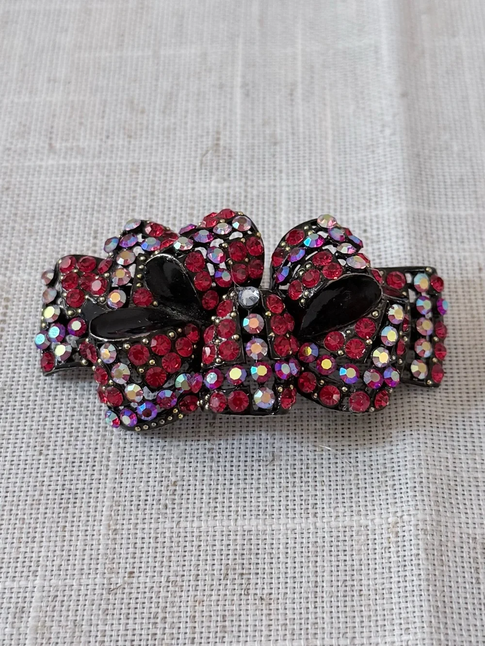 red rhinestone bow hair claw clip embellished with sparkling red and aurora bore